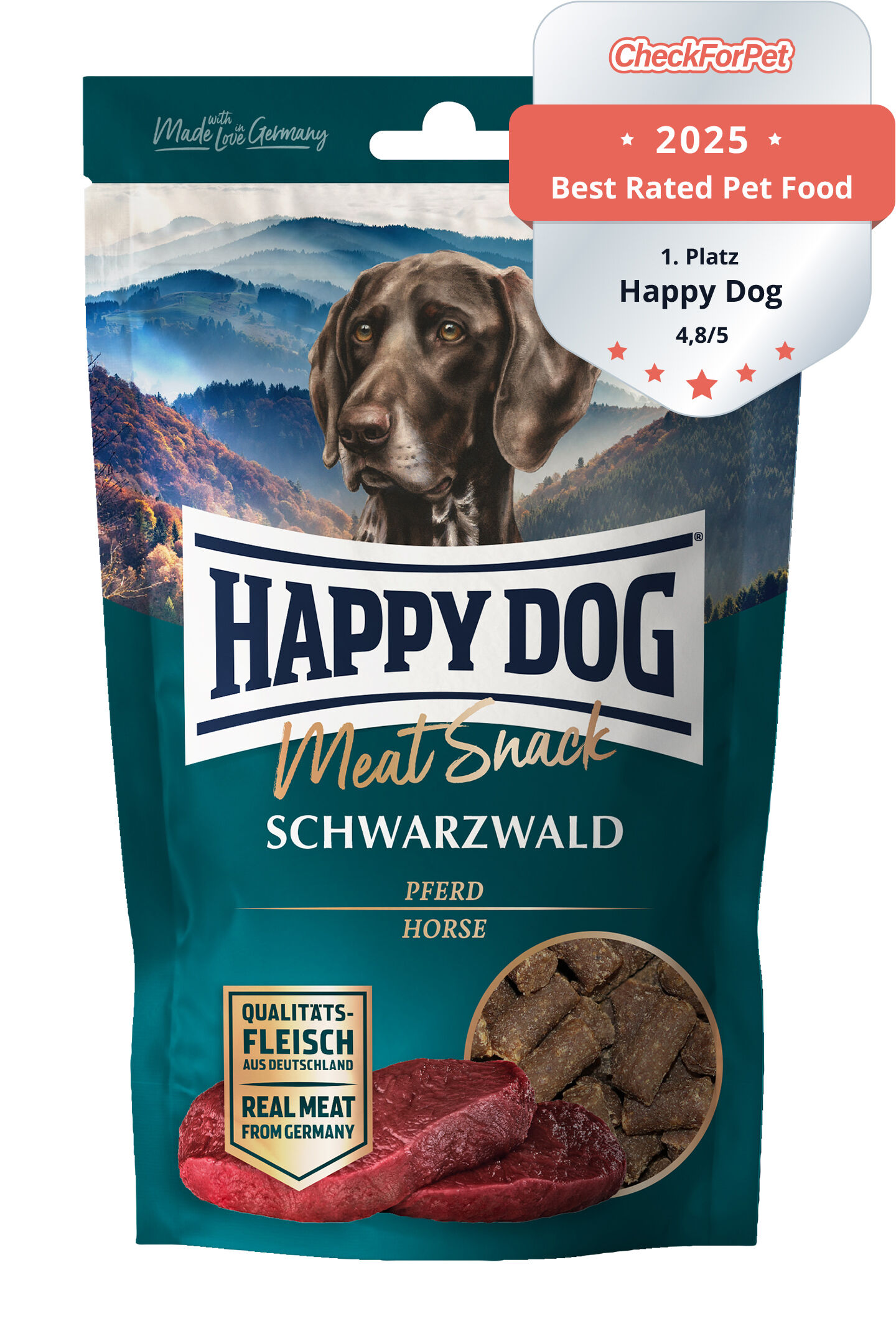 Hundesnack-Tüte mit Aufdruck "Happy Dog Meat Snack Schwarzwald Pferd". Tüte zeigt Hundekopf, Berge im Hintergrund und Fleischstücke, betont Qualität aus Deutschland.