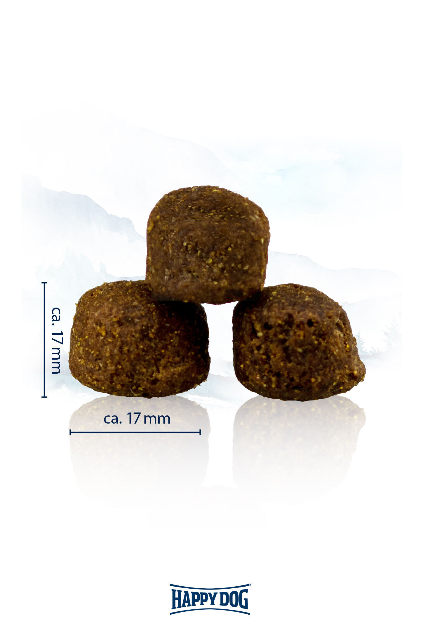 Drei braune, runde Stücke Heimtiernahrung sind pyramidenförmig gestapelt, etwa 17 mm im Durchmesser. Unten befindet sich das Logo "Happy Dog".