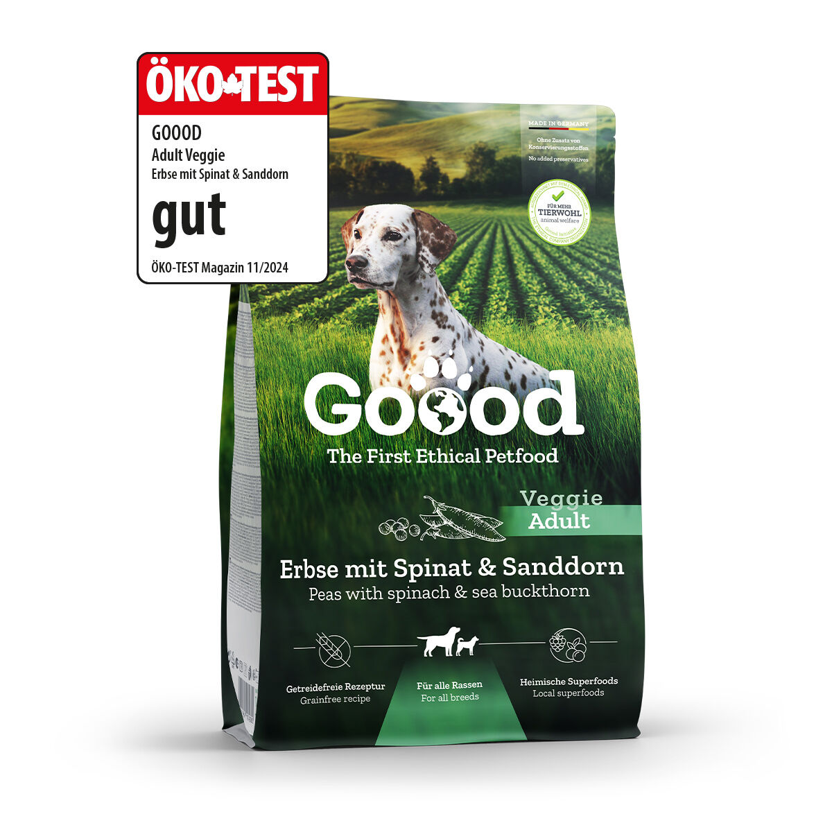 Hund auf Verpackung - steht vor grüner Landschaft – Text: „Goood, The First Ethical Petfood, Veggie Adult, Erbse mit Spinat & Sanddorn, Getreidefreie Rezeptur, Für alle Rassen, Heimische Superfoods“.
