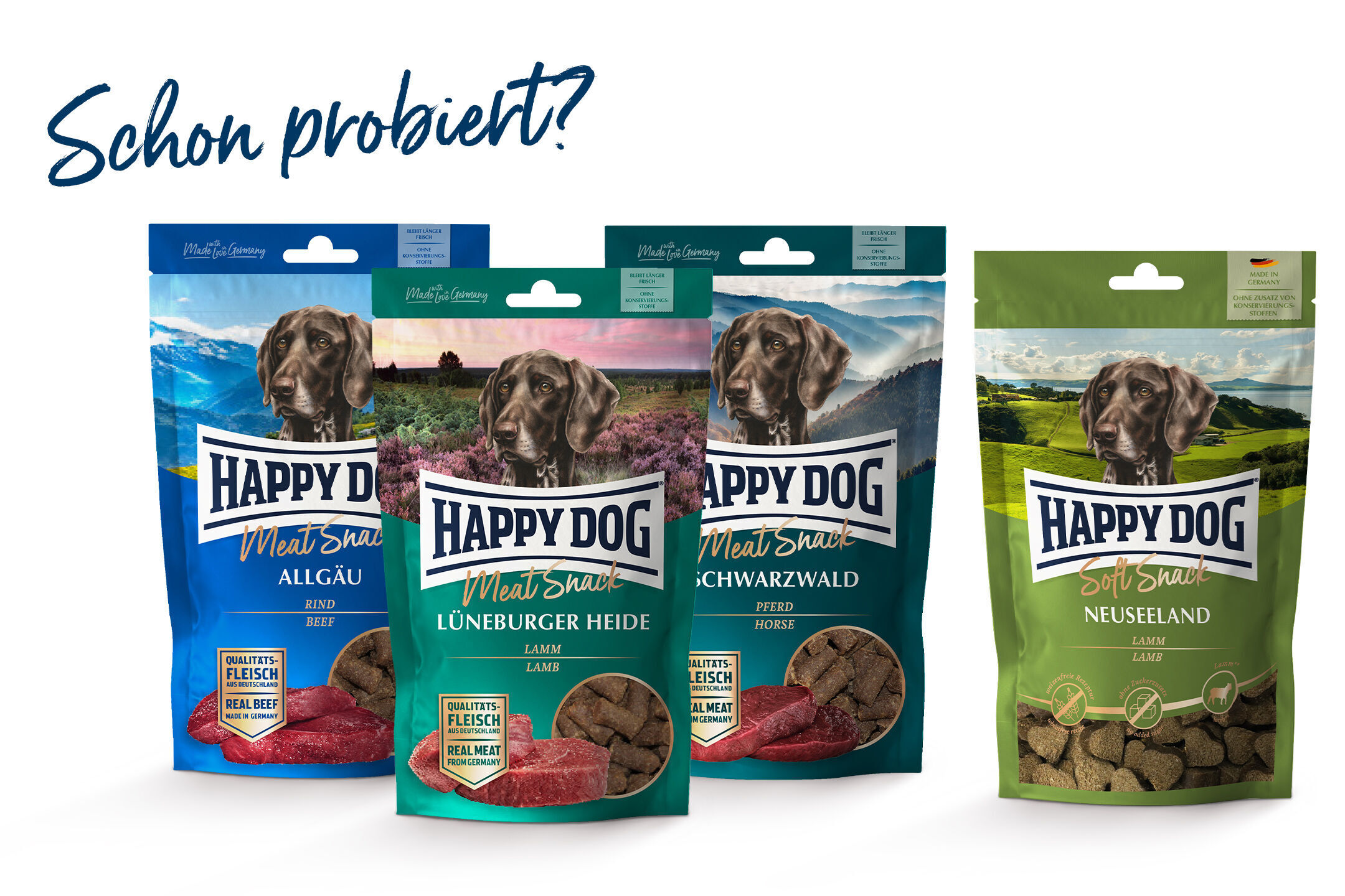 Vier Hundesnack-Verpackungen der Marke Happydog mit verschiedenen Geschmacksrichtungen und der Frage „Schon probiert?“ im Hintergrund.
