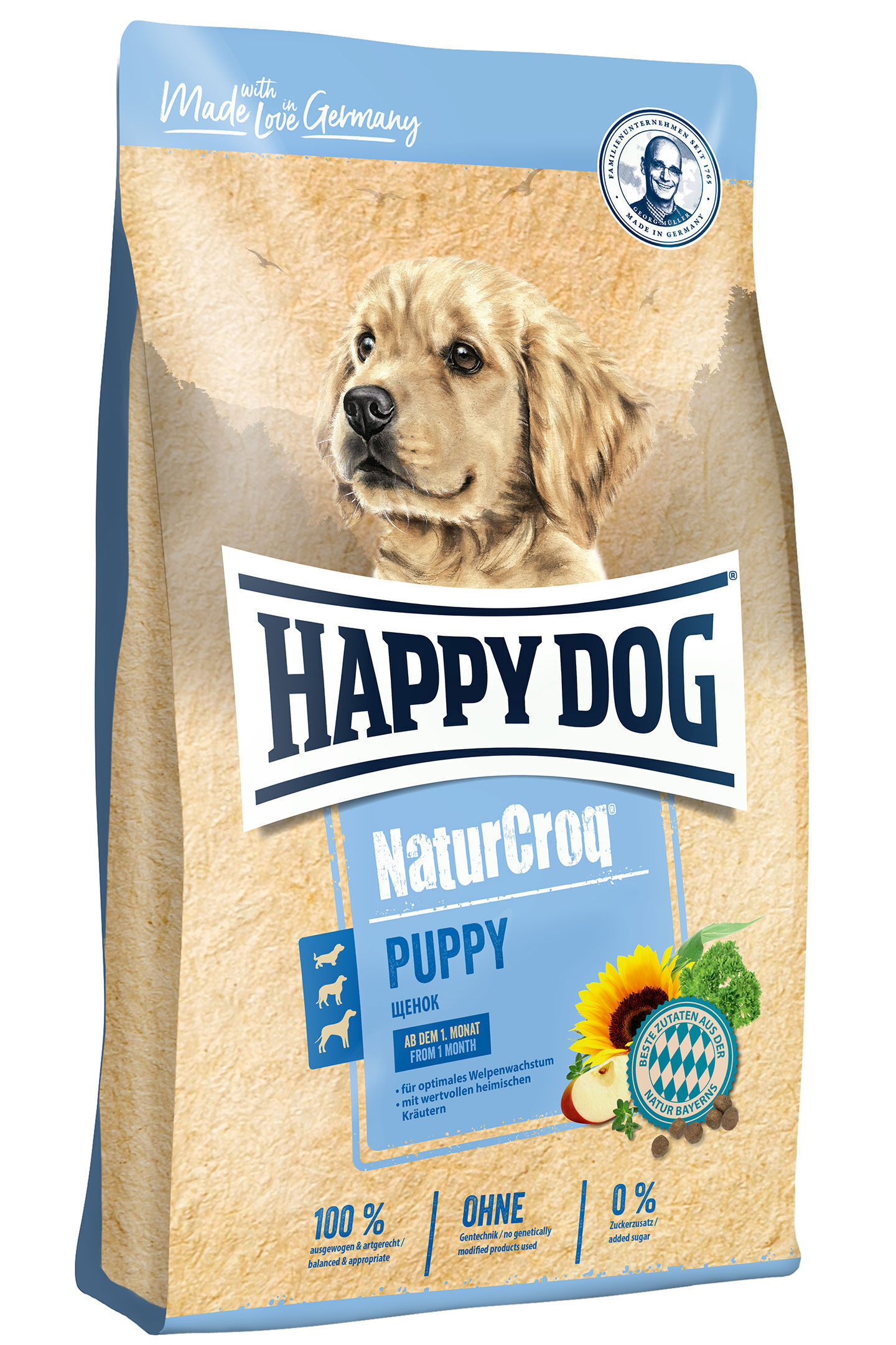 Eine Packung Hundetrockenfutter zeigt einen Welpen und trägt den Text: "HAPPY DOG NaturCroq PUPPY, Made with love in Germany, ab dem 1. Monat."