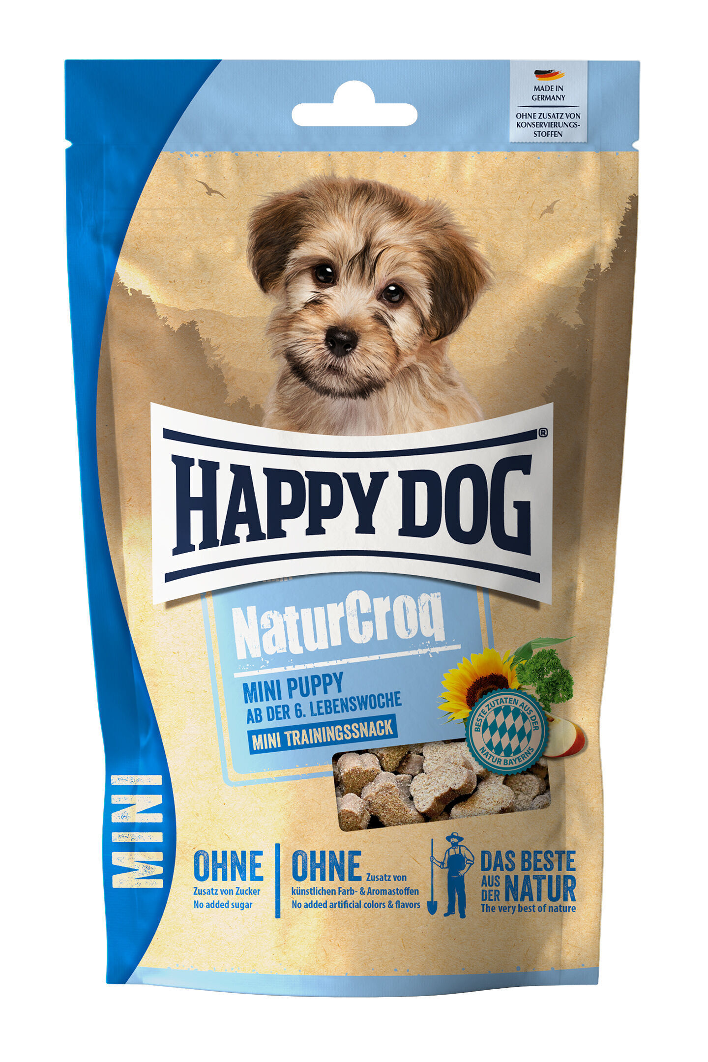 Verpackung mit Hundebild und der Marke „Happydog“. Text: „NaturCroq MINI PUPPY ab der 6. Lebenswoche, MINI TRAININGSSNACK, OHNE Zusatz von Zucker, OHNE künstliche Farb- & Aromastoffe, DAS BESTE AUS DER NATUR“.