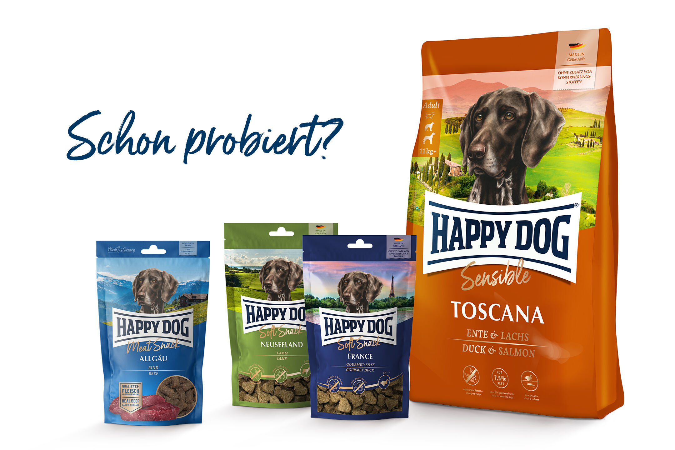 Verpackungen von Happydog-Hundefutter mit verschiedenen Sorten (Allgäu, Neuseeland, France, Toscana) sind abgebildet. Der Text „Schon probiert?“ steht links.