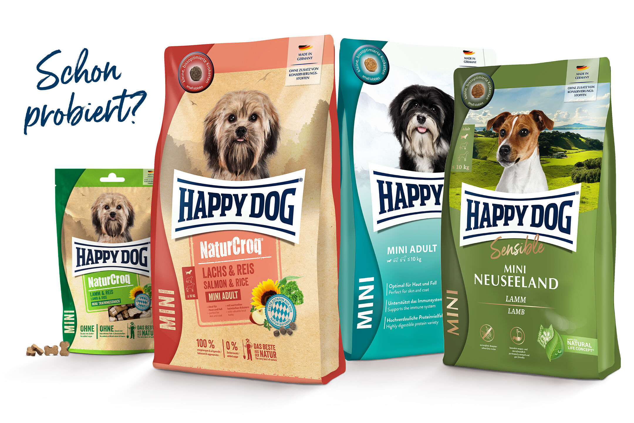 Hundetrockenfutterverpackungen von Happydog mit verschiedenen Geschmacksrichtungen, präsentiert im Vordergrund. Text: "Schon probiert?". Made in Germany, ohne Zusatz von Konservierungsstoffen.