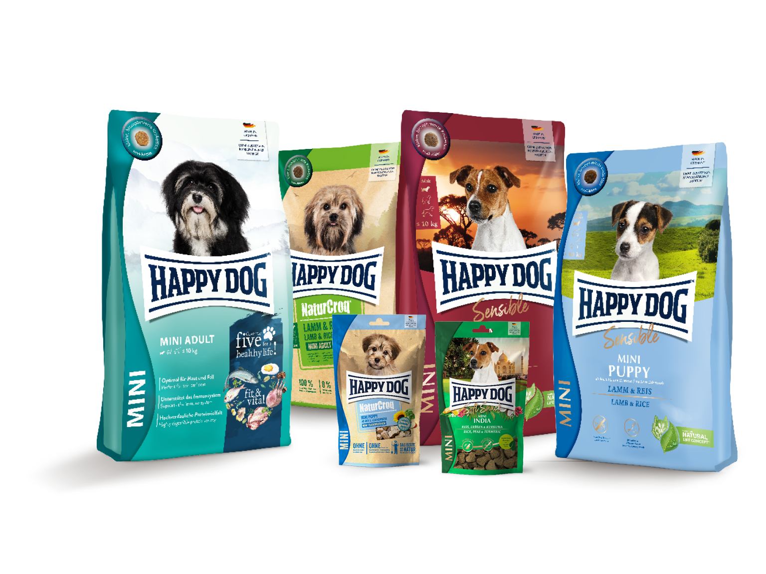 Hunde-Trockenfutterpackungen der Marke Happydog, verschiedene Sorten für unterschiedliche Altersgruppen und Ernährungsbedürfnisse, aufgereiht vor weißem Hintergrund.