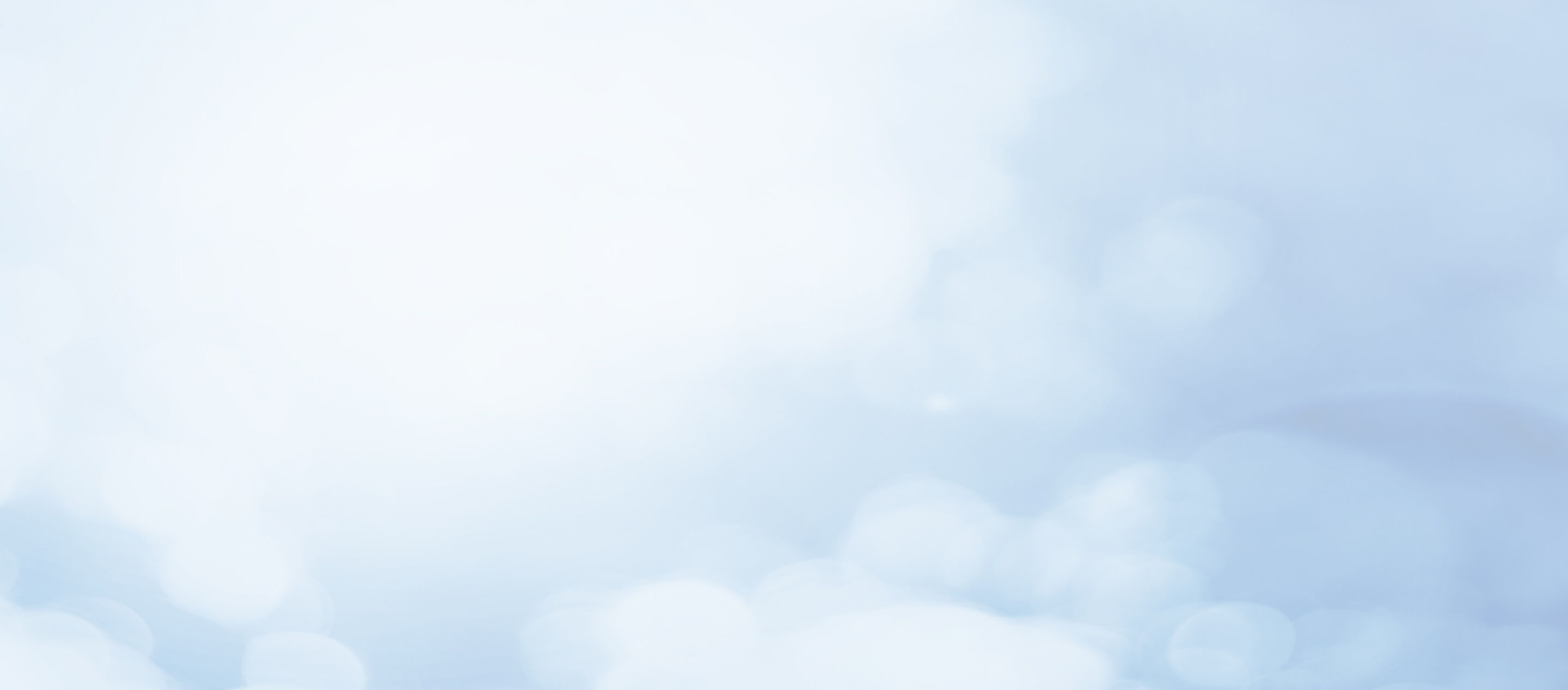 Verschwommene, hellblaue, kreisförmige Lichter erscheinen in einem diffusen Muster auf einem klaren, blauen Hintergrund, was eine ruhige und sanfte Atmosphäre schafft.