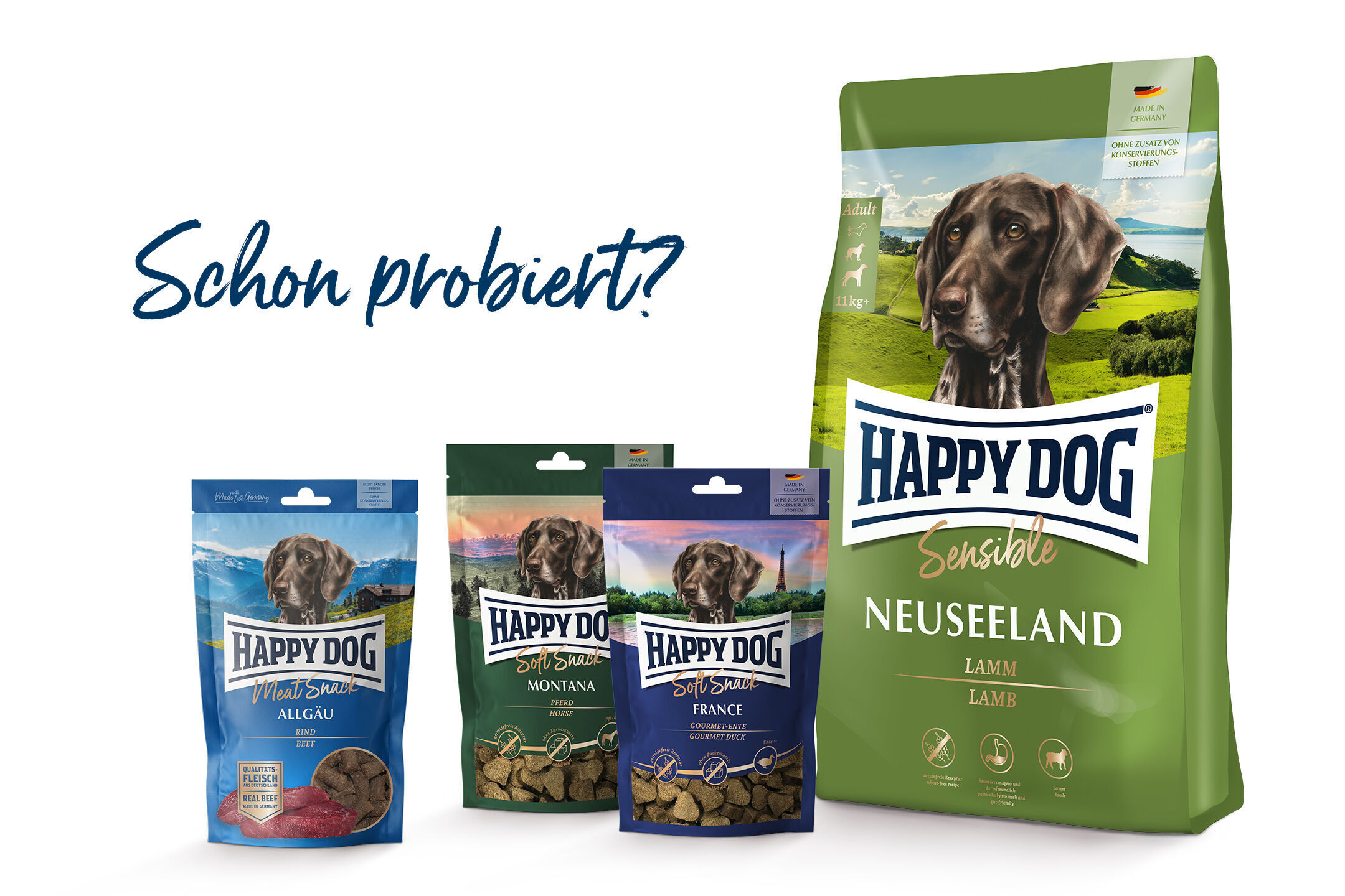 Verpackungen von Happydog-Hundefutter in verschiedenen Sorten, darunter Neuseeland Lamm. Text: "Schon probiert?" im Hintergrund.