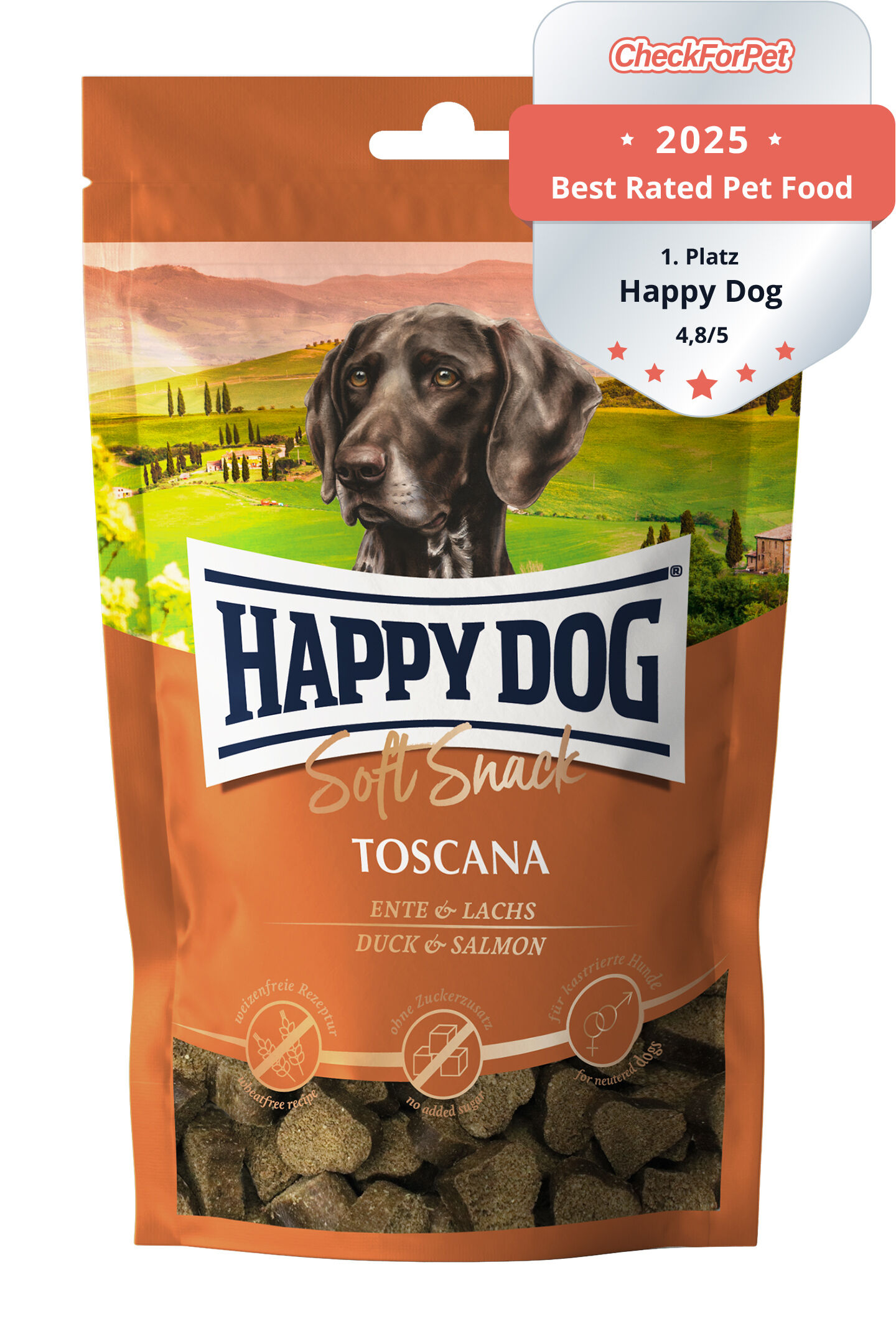 Packung Hundesnacks mit der Aufschrift "Happy Dog Soft Snack Toscana, Ente & Lachs." Illustration eines Hundes und toskanischer Landschaft im Hintergrund. "Made in Germany, ohne Zusatz von Konservierungsstoffen."