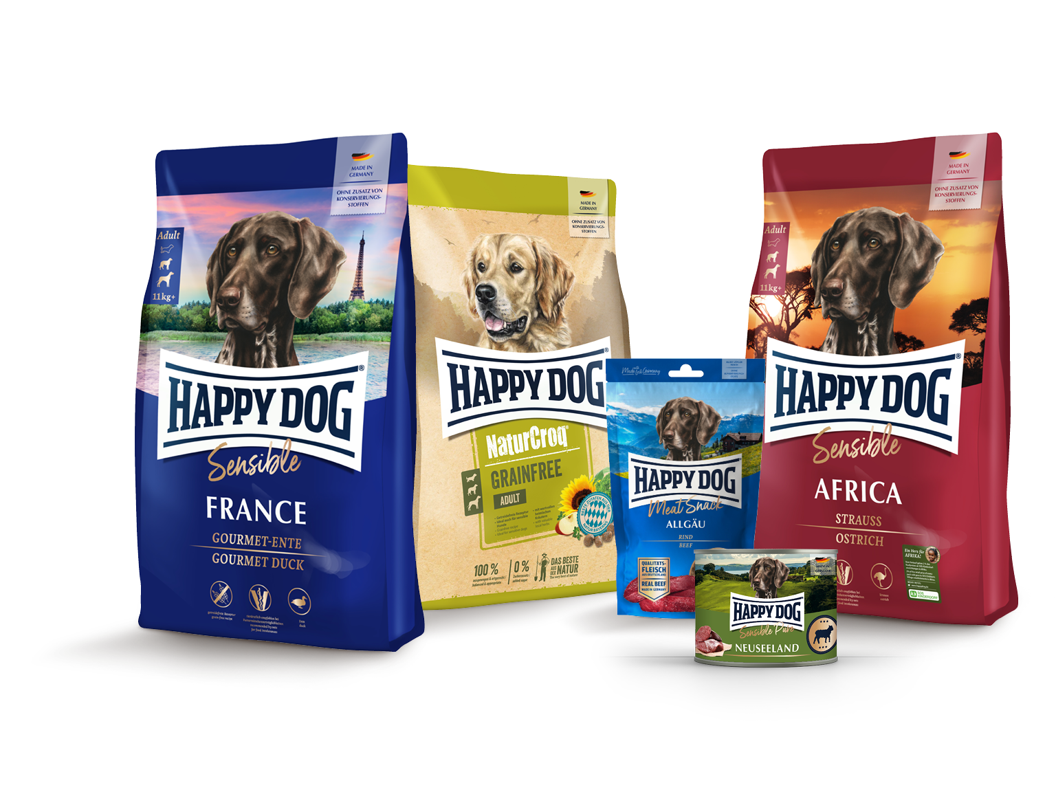 Hundetrocken- und Nassfutter von Happy Dog in verschiedenen Verpackungen, darunter Geschmacksrichtungen wie Frankreich und Afrika, dekorativ arrangiert vor weißem Hintergrund.