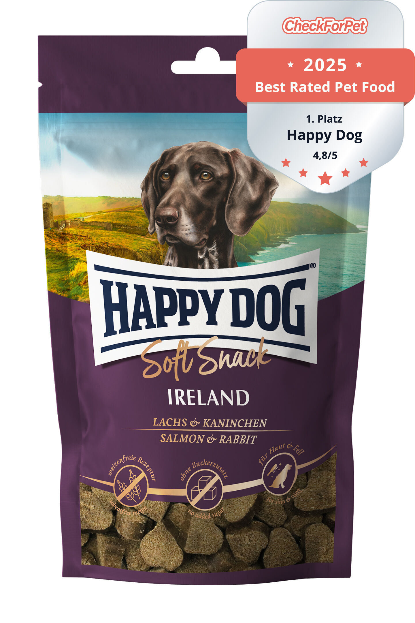 Verpackung mit Hundebild, Landschaft im Hintergrund. Text: "Happy Dog Soft Snack Ireland Lachs & Kaninchen, Made in Germany, ohne Zusatz von Konservierungsstoffen". Enthält kleine braune Snacks.