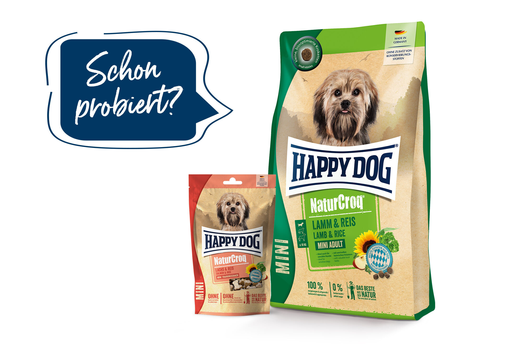 Zwei Happydog Futtersäcke mit Hundemotiv, einer grün (Lamm & Reis), einer orange (Lachs & Reis). Text in Sprechblase: "Schon probiert?".