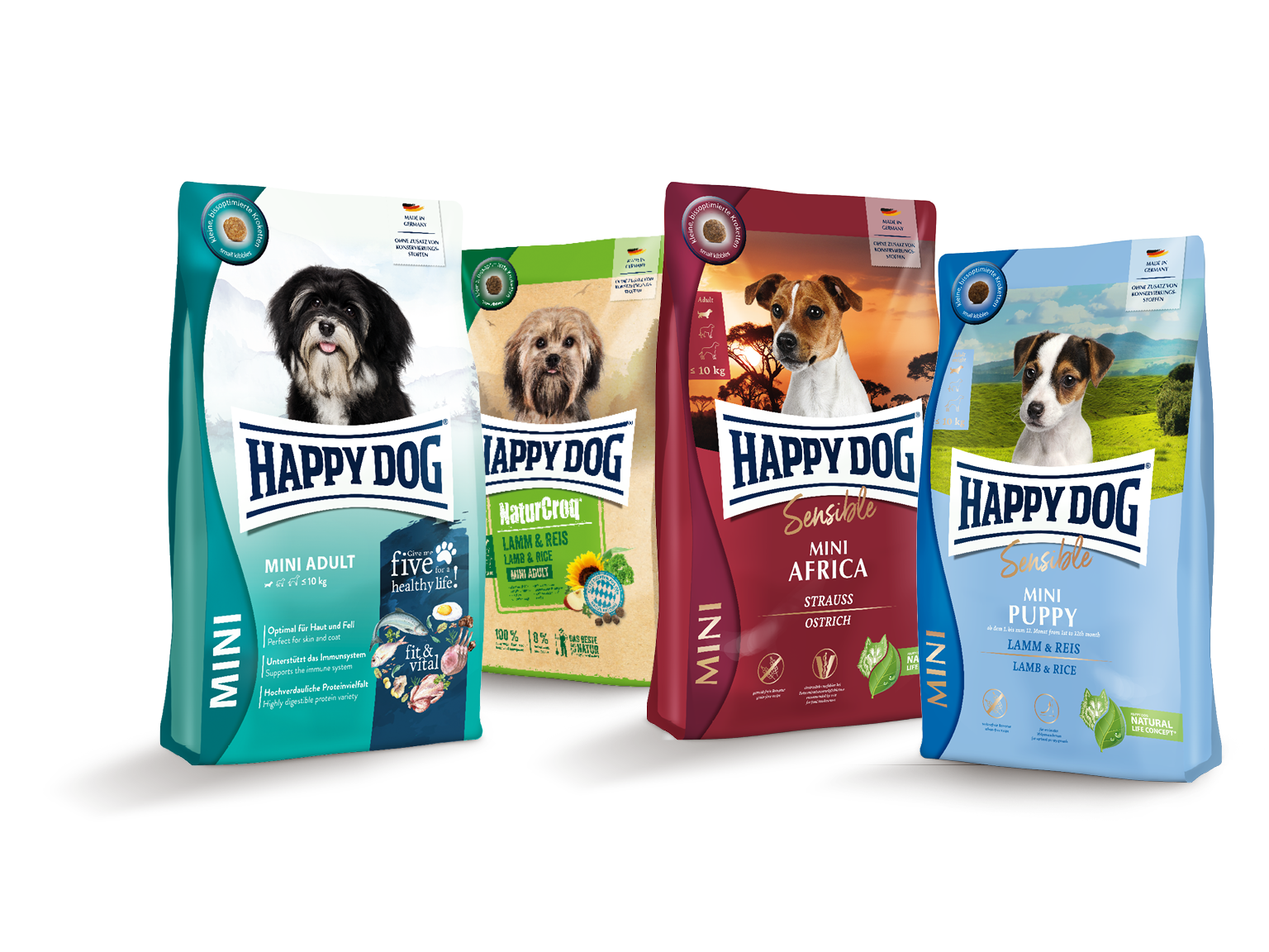 Vier Verpackungen von Happydog-Trockenfutter mit verschiedenen Hundeabbildungen und Sortenbeschreibungen wie "Mini Adult" und "Mini Africa", jeweils in unterschiedlichen Farben gestaltet.