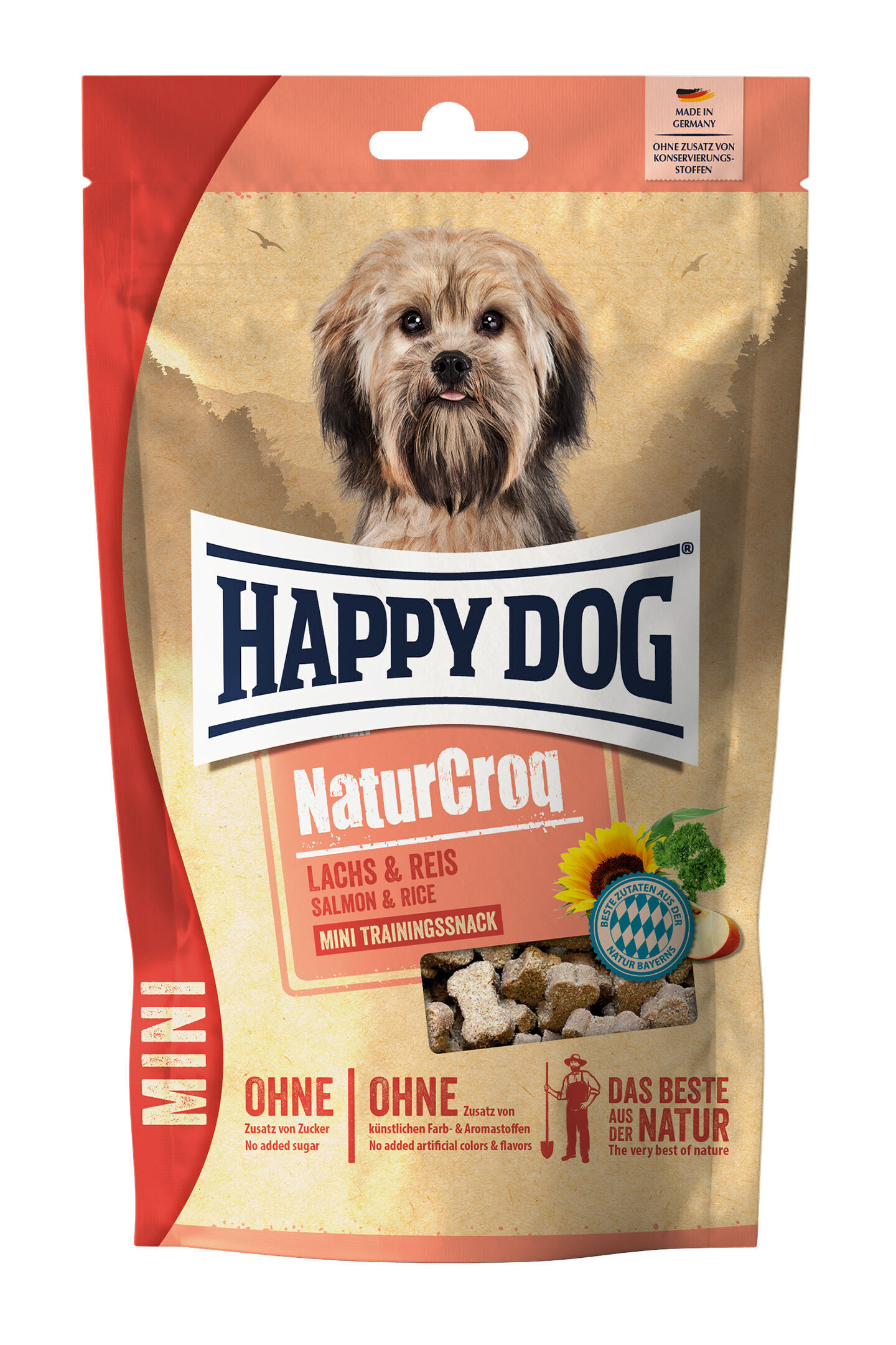 Verpackung mit kleinem Hundebild, Markenname „Happy Dog“ oben, Text: „NaturCroq Lachs & Reis, Mini Trainingssnack, OHNE Zusatz von Zucker und künstlichen Farb- & Aromastoffen, DAS BESTE AUS DER NATUR“.