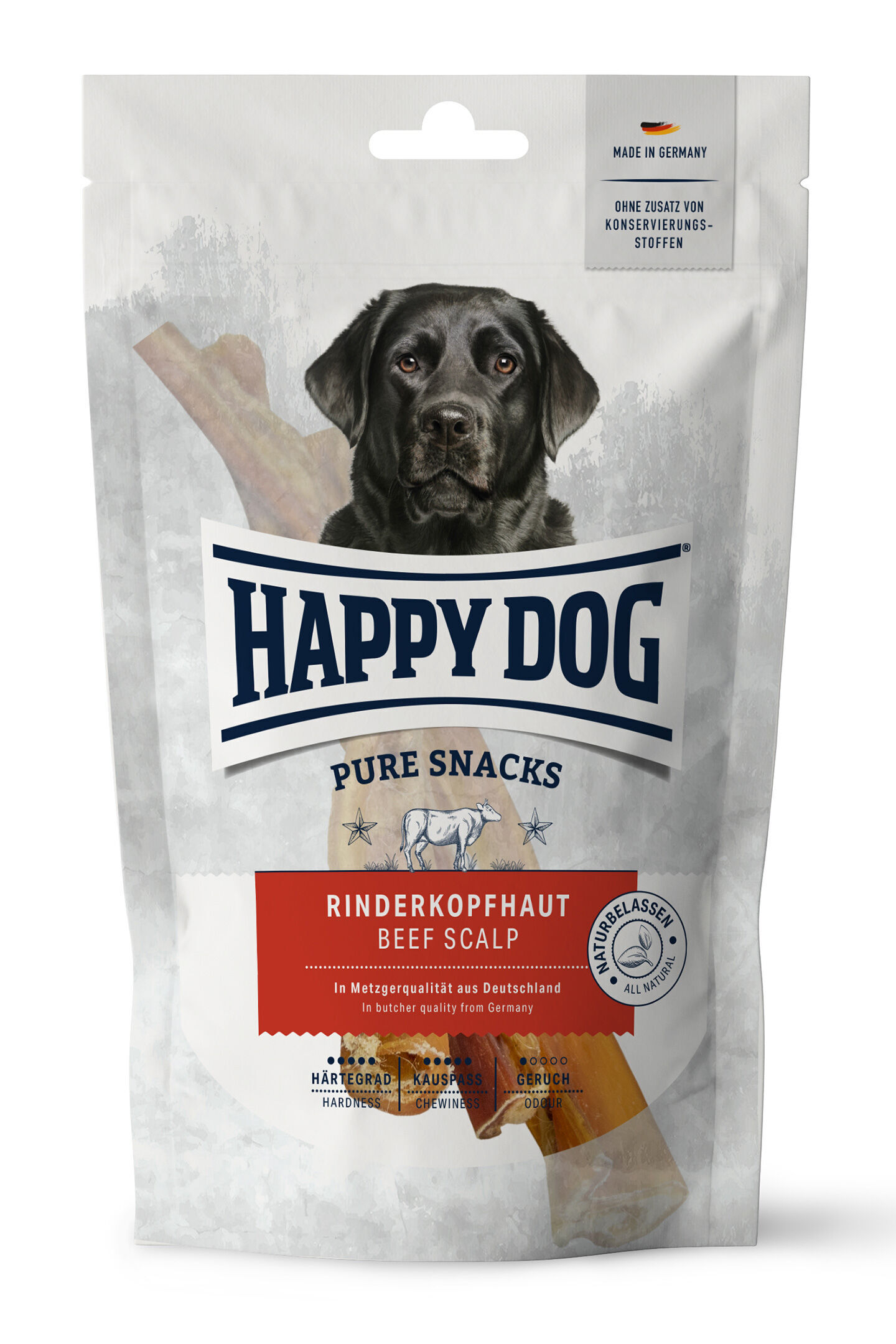 Verpackung mit schwarzem Hund, „Happydog Pure Snacks“ markiert, enthält Rinderkopfhaut. Text: „In Metzgerqualität aus Deutschland“, „Ohne Zusatz von Konservierungsstoffen“. Abbildung einer Kuh und Eigenschaften Symbole.