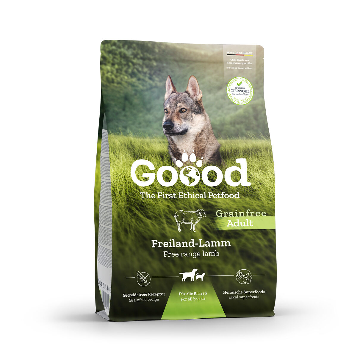 Hundefutterverpackung von Goood mit Getreidefrei-Label, Freiland-Lamm-Bild und Hinweis auf heimische Superfoods auf einer grünen Wiese, Hundebild im Hintergrund.