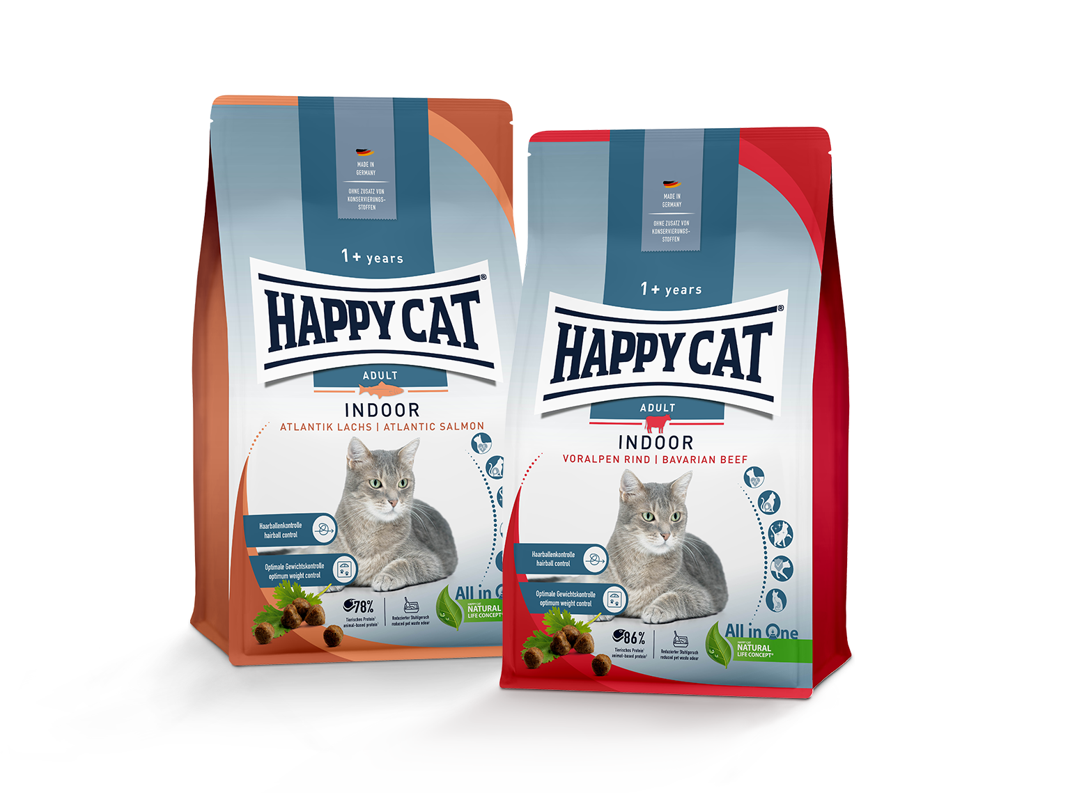 Zwei Happy Cat Trockenfutter-Packungen für erwachsene Katzen, „Indoor Atlantik Lachs“ und „Indoor Voralpen Rind“, mit Katzenbildern und Produktinformationen.