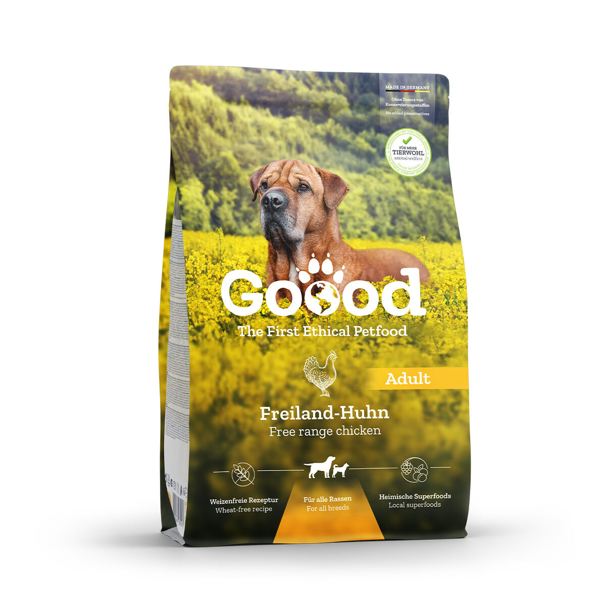 Hund abgebildet auf gelbem Blumenfeld; Produktverpackung mit Aufschrift "Goood - The First Ethical Petfood," "Freiland-Huhn," "Adult." Enthält Beschreibungen wie "wheat-free recipe" und "local superfoods."