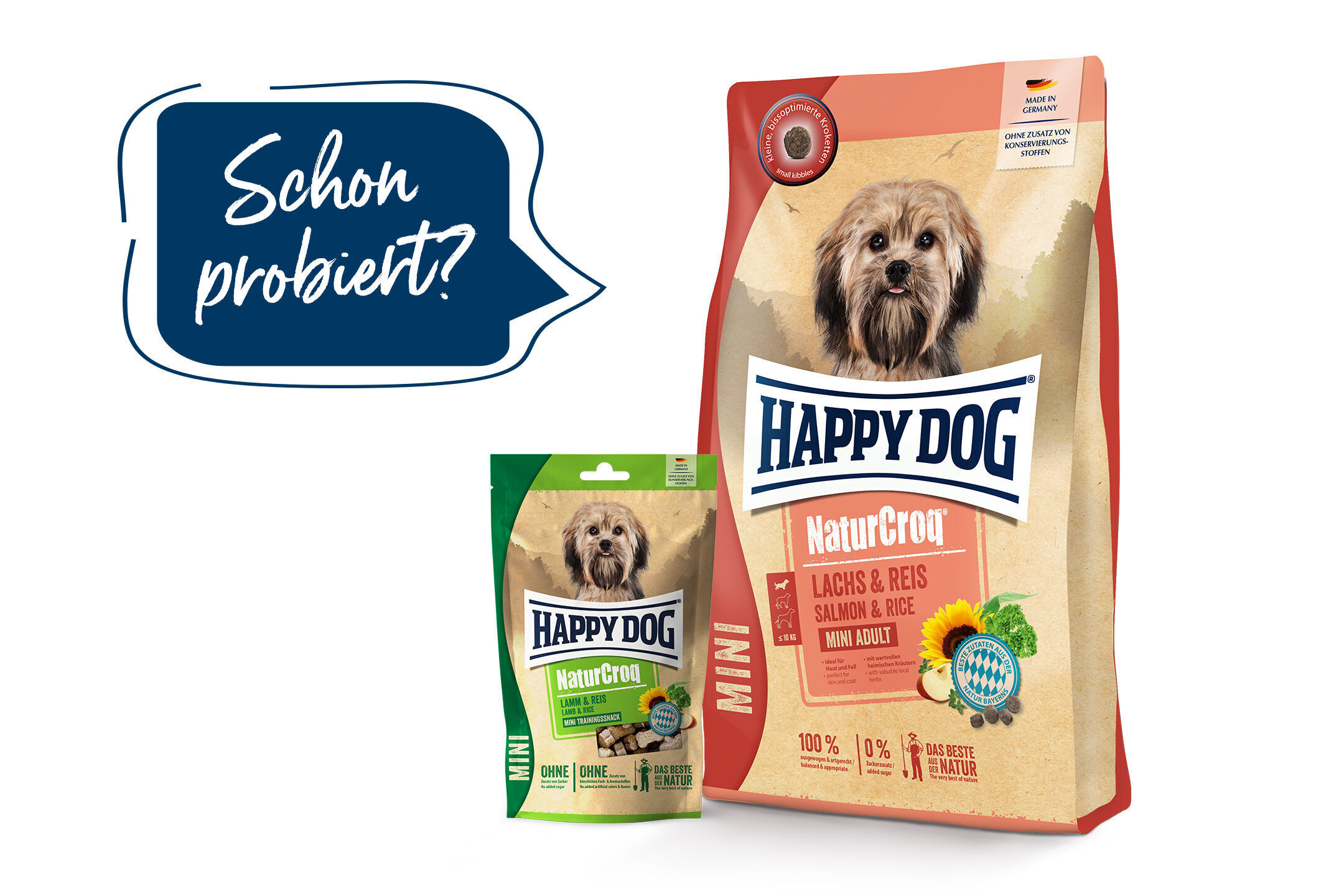 Zwei Packungen Hundetrockenfutter von Happydog, Sorten Lachs & Reis und Lamm & Reis, mit Hundefoto. Aufschrift: „Schon probiert?“.