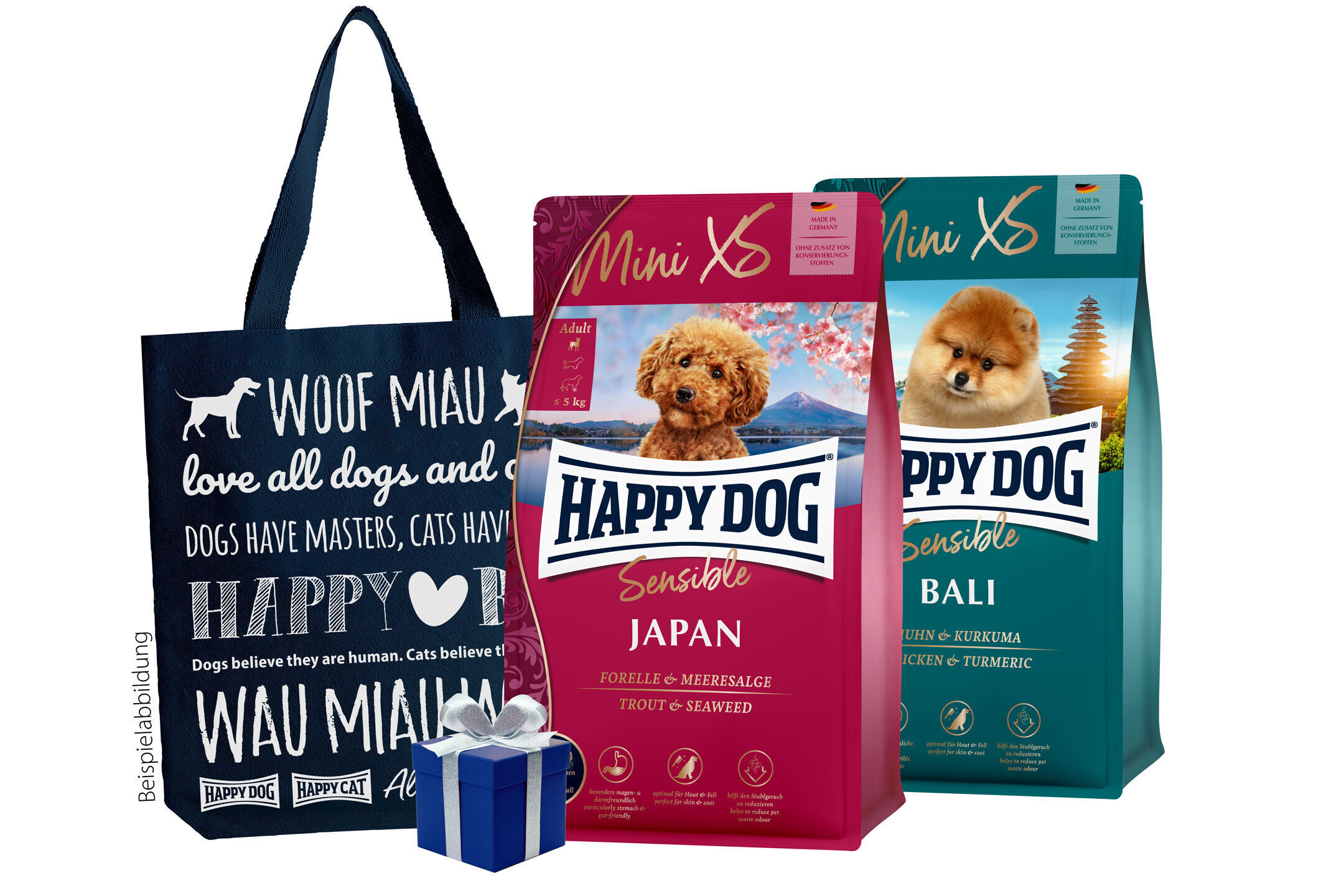 Probiertasche Sensible Mini XS Tasche mit Hunde- und Katzenmotiven neben zwei Happy Dog Hundefutterpackungen "Japan" und "Bali", dekoriert mit einer Geschenkbox.